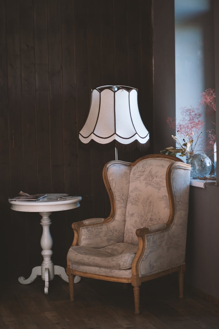 The Art of Drawing Readers In: Your attractive post title goes here Charming vintage interior with an armchair, elegant lamp, and side table. Perfect for cozy settings.