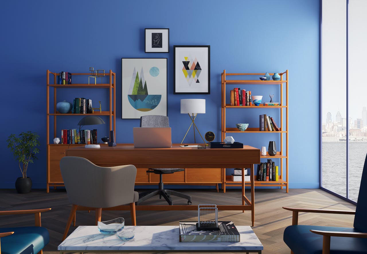 Services Elegantly decorated home office with modern furniture and a blue wall.